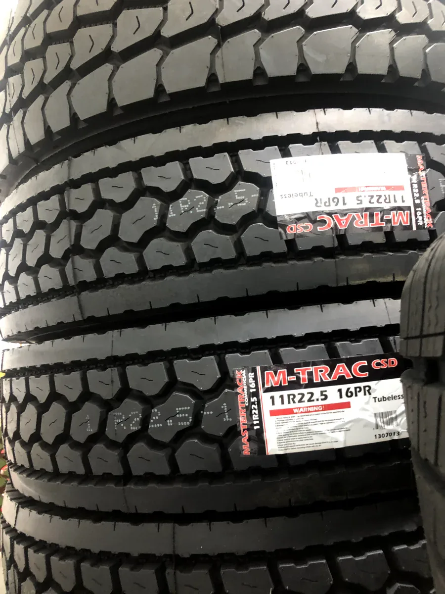 11R22.5 truck tires at Edwin Tire Shop in Brentwood MD Mastertrack M-TRAC commercial truck tires stacked at Edwin Tire Shop