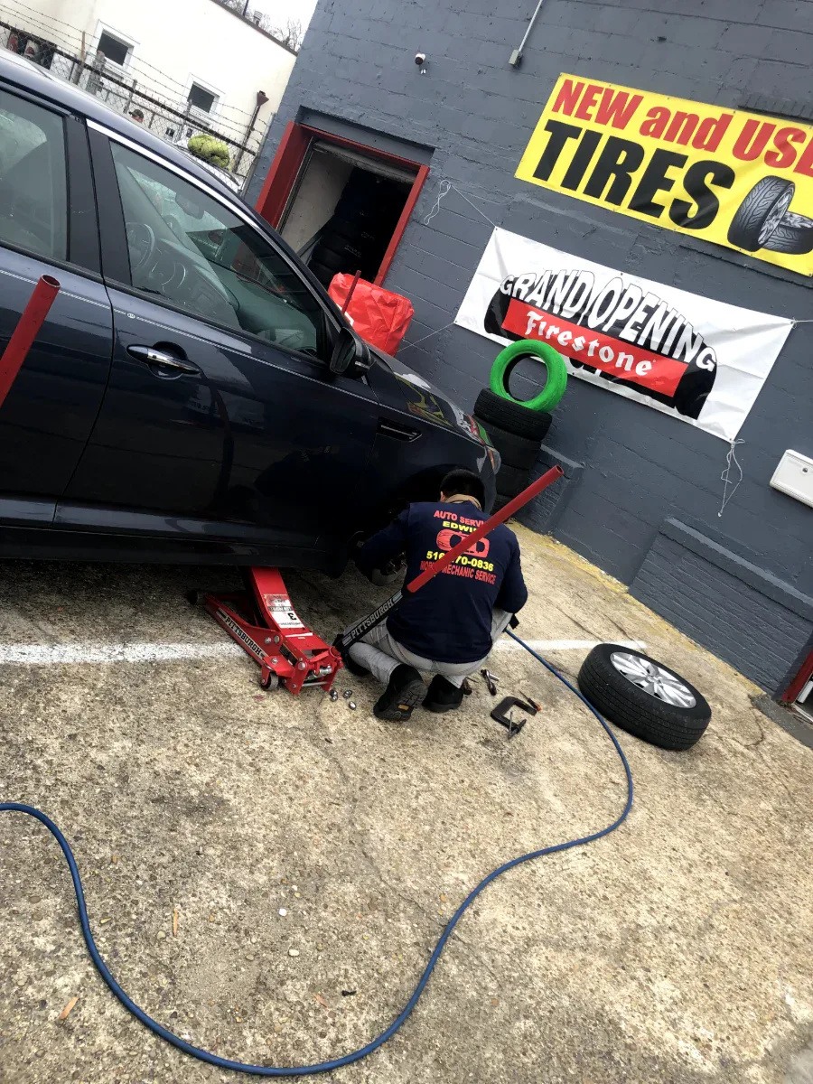Walk-in tire help at Edwin Tire Shop in Brentwood MD Edwin Tire Shop technician servicing a car outside the shop