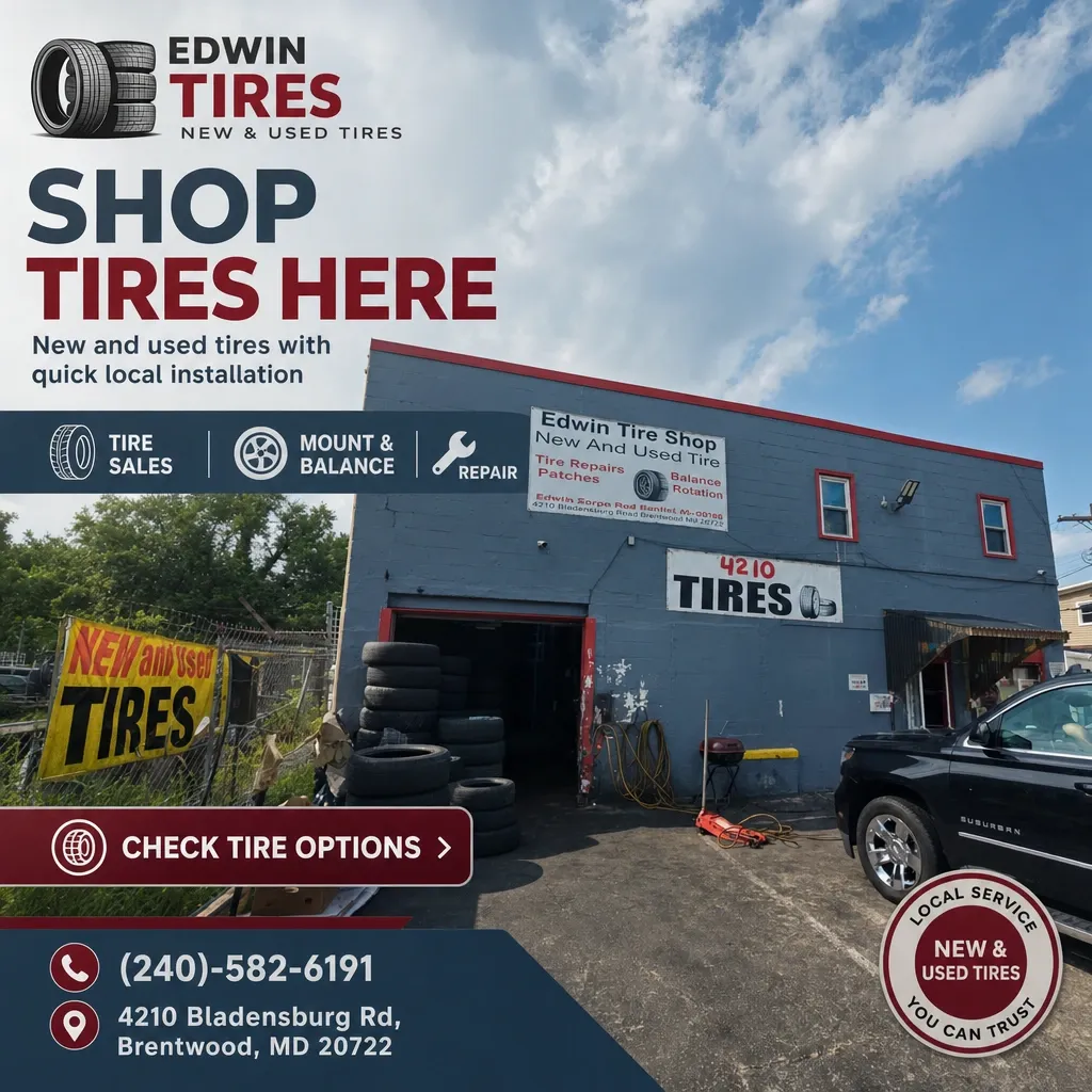 Exterior of Edwin Tires shop with stacked tires by an open garage bay, prominent signage and service icons.
