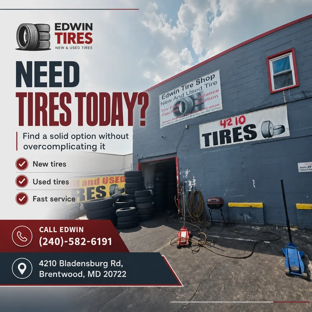 Exterior of Edwin Tires shop in Brentwood showing stacked tires, signage, and service equipment outside the garage.