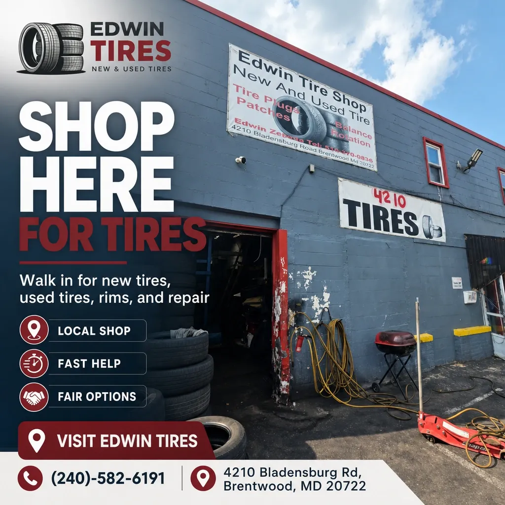 Exterior of Edwin Tires storefront and open garage with stacked tires, hose reels, tools, and signage.