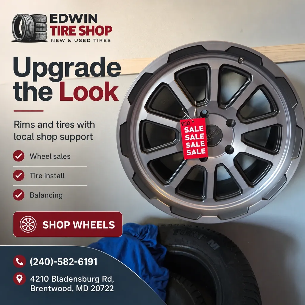 Polished alloy wheel with red sale tag displayed on a shop wall above stacked tires and a Shop Wheels callout.