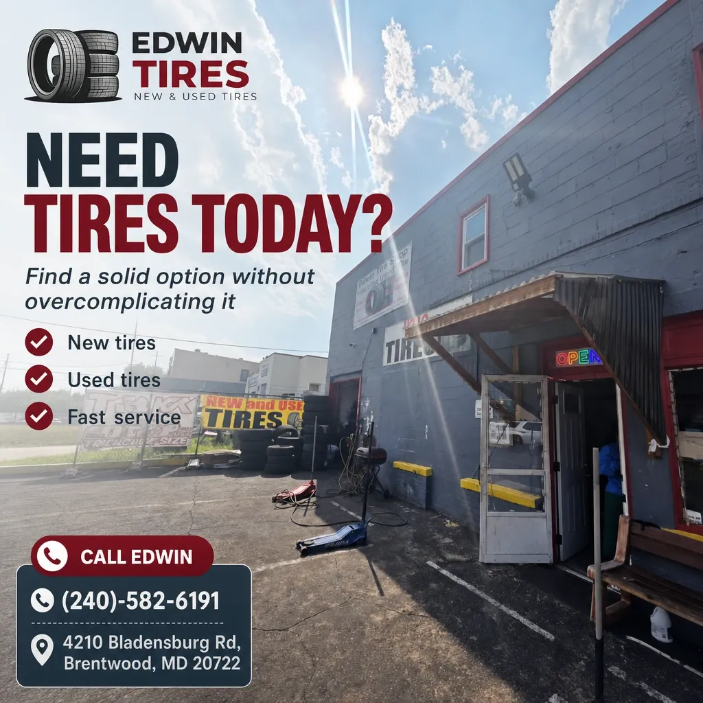 Exterior of Edwin Tires shop in Brentwood with stacked tires, open service bay, and promotional signage under a sunny sky.