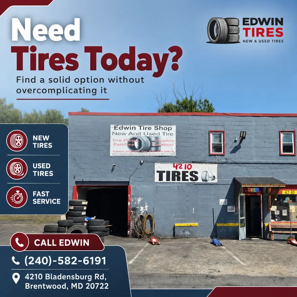 Front exterior of Edwin Tires shop in Brentwood with stacked tires, open garage door, and promotional 'Need Tires Today' graphic